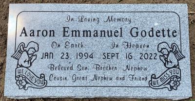 individual gray granite headstone with praying angels emblems